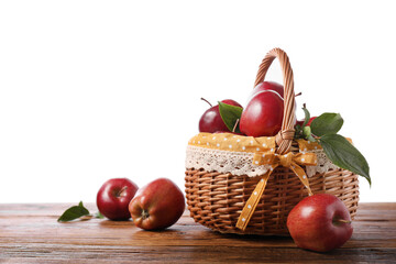 Ripe red apples in wicker basket on wooden table against white background. Space for text