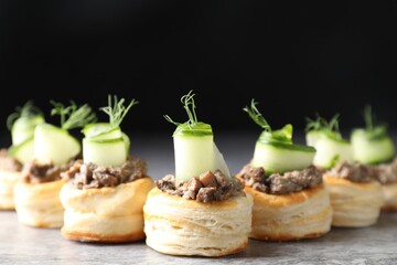 Delicious puff pastry with mushrooms, cucumber and dill on grey table
