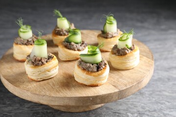 Delicious puff pastry with mushrooms, cucumber and dill on grey table