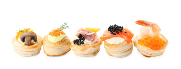 Different delicious puff pastry snacks isolated on white