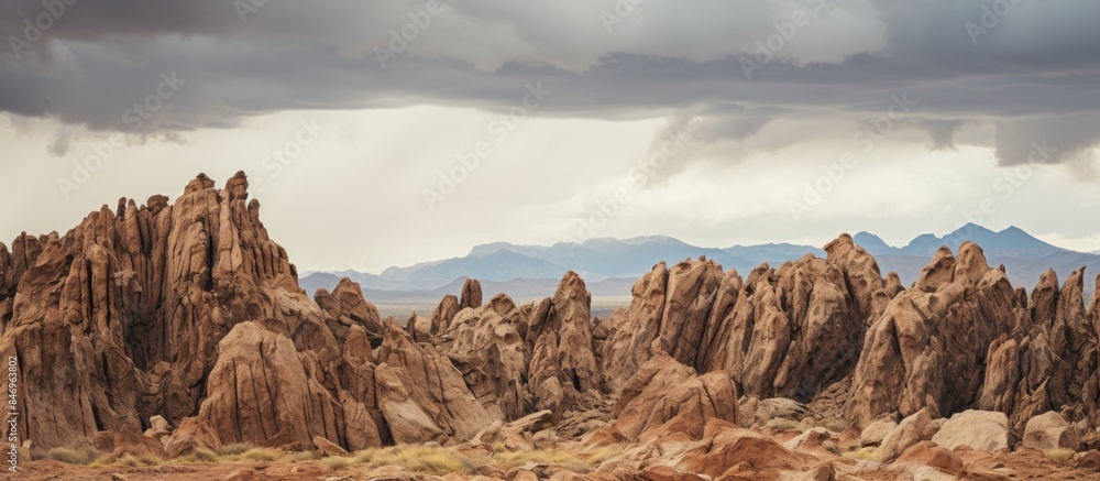Aufkleber Cluster of rocks in the desert with majestic mountains in the background creating a scenic view. with copy space image. Place for adding text or design