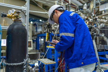 Asian engineer working at Operating hall,Thailand people wear helmet  work,He worked with diligence...