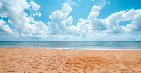 Fototapeta premium Beautiful summer background with golden sand on the beach and blue sky with clouds over sea water