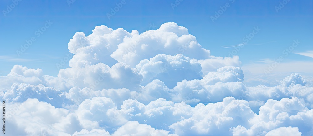 Poster Large cloud positioned above layers of white clouds against a blue sky. with copy space image. Place for adding text or design