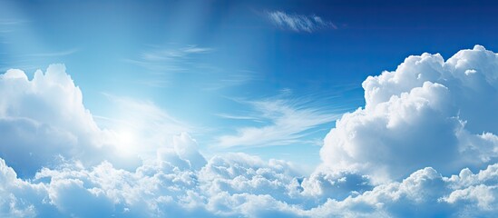 Up in the sky, a plane gracefully maneuvers through the fluffy clouds in a sunny atmosphere. with copy space image. Place for adding text or design