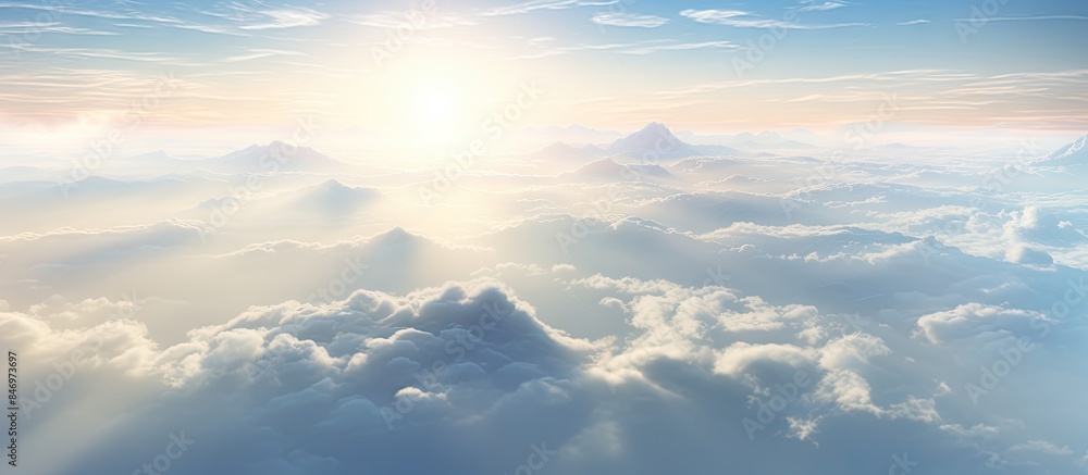 Poster Bright sun rays breaking through dense mist and illuminating the cloudy sky. with copy space image. Place for adding text or design
