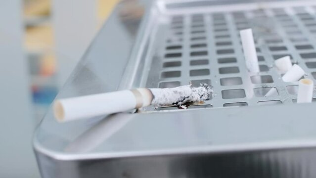 Smoldering cigarette in an ashtray
