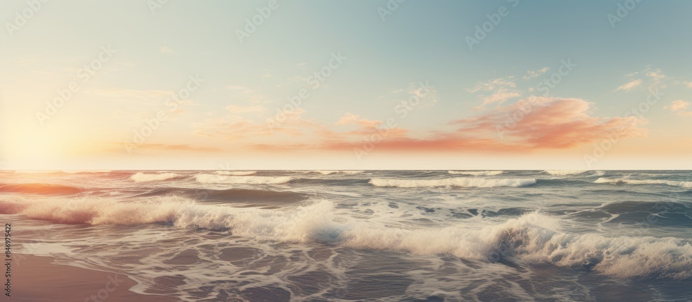 Poster Waves crashing on a beautiful beach at sunset with a picturesque view of the sea seashore landscape. with copy space image. Place for adding text or design