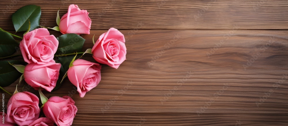 Poster pink roses arranged on a wooden table with a vibrant green leaf accent. with copy space image. place