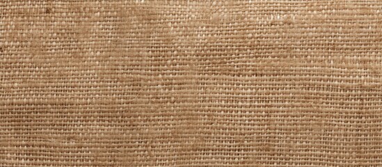Brown cloth with a subtle light brown texture in a close-up view, showcasing a rich and tactile beige burlap fabric. with copy space image. Place for adding text or design