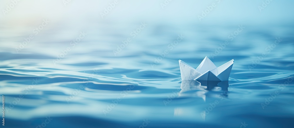 Poster Paper boat gracefully floats on water with sun's rays glistening on its surface. with copy space image. Place for adding text or design
