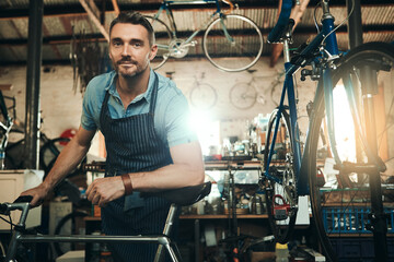 Man, bicycle shop and portrait for maintenance job, startup with transport service. Bike, mechanic...