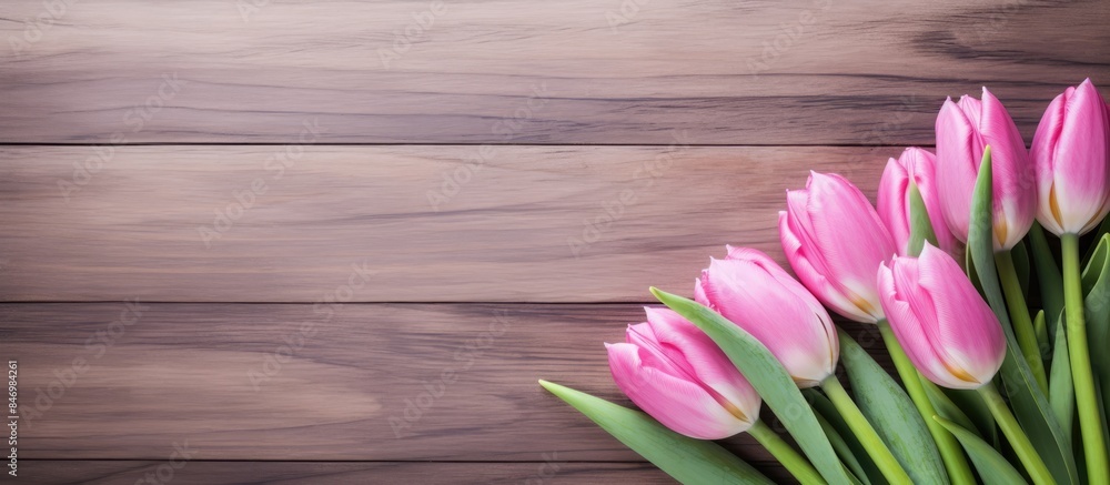 Poster pink tulips elegantly arranged on an aged wooden background creating a charming rustic display. with