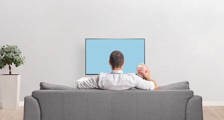 Rear view shot of a man in front of a tv screen