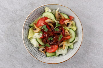 Asian beef salad with vegetables and nuts in a white bowl on a dark background. Asian food concept.