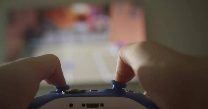 Close-up hands holding a joystick computer game. Male hands playing with a joystick computer games. Using controller playing video games - close up of hands and joypad