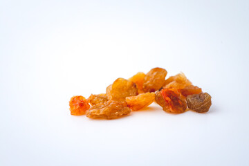 Golden dried raisins isolated on white background