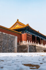 Fototapeta premium The Forbidden City, covered in snow on the ground in winter.