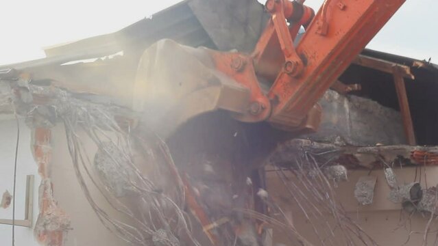 Building demolition, excavator and twisted rebars
