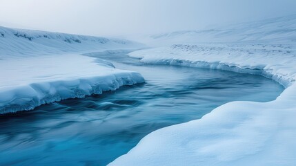Fototapeta premium A frozen river winds through a snowy landscape, with ice formations lining its edges. The water is a clear blue, contrasting with the white snow. The air is calm and still.