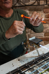 Murano Glassblowing Artisan in Venice, Traditional Handmade Craftsmanship, Glass Working Techniques, Creative Process in Murano Italian Island Workshop, Flame and Heat Manufacturing Skillful Craftsman