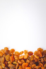 Golden dried raisins isolated on white background