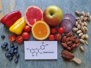 Quercetin rich food. Structural chemical formula of quercetin with fresh fruit and vegetable....