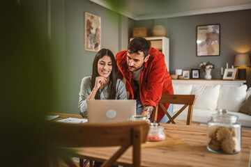Woman work from home on laptop while boyfriend help and support her