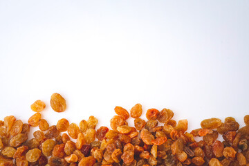 Golden dried raisins isolated on white background