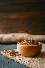 Flax seed in a wooden bowl. Close-up