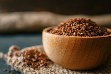 Flax seed in a wooden bowl. Close-up