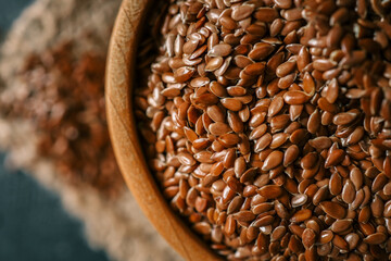 Flax seed in a wooden bowl. Close-up