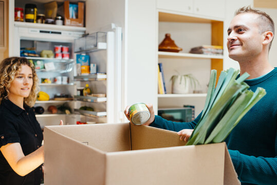 Friends unpacking groceries