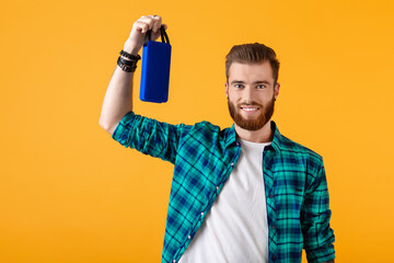 stylish young man holding wireless speaker