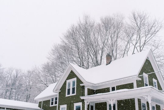 green old home in massachusetts during noreaster