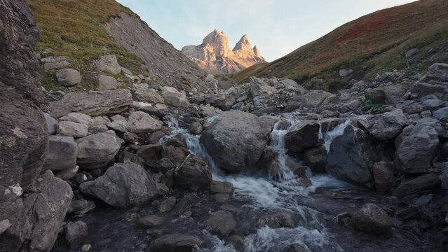 Landscape of Iconic mountain peak of Aiguilles d Arves with waterfall flowing in French Alps at Savoie, France