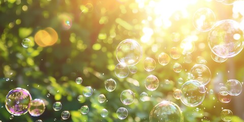 bunch of bubbles floating in the air near a trees in the background with the sun shining through