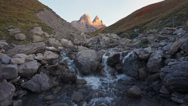 Landscape of Iconic mountain peak of Aiguilles d Arves with waterfall flowing in French Alps at Savoie, France
