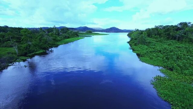 Drone flying in the clouds over the river in Amap&aacute;, Amazon Brazil