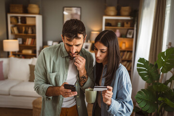 Couple and buy online on mobile phone with credit card at home