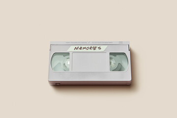 Grey retro video cassette with inscription Memories lying in studio