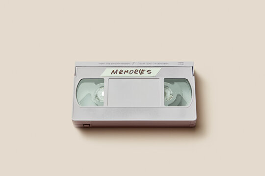 Grey retro video cassette with inscription Memories lying in studio