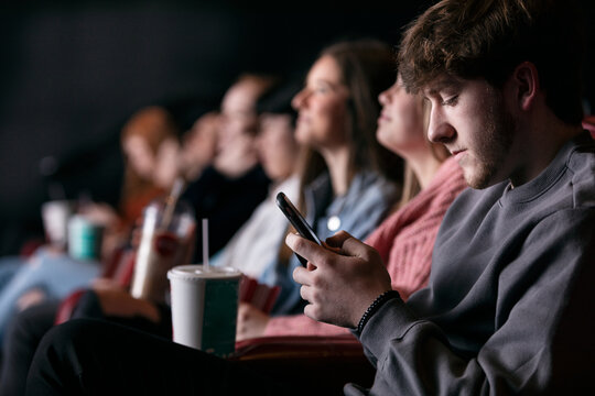 Movies: Male Teen Uses Cell Phone During Movie