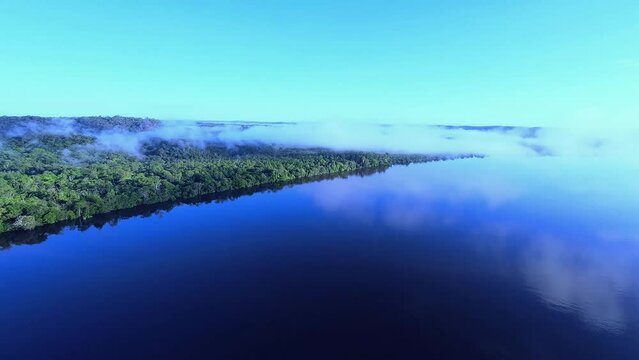 Drone flying in the clouds over the river in Amap&aacute;, Amazon Brazil
