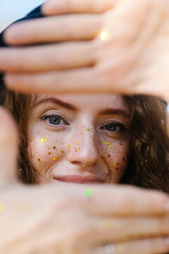 A woman with gold sparkles on her face 