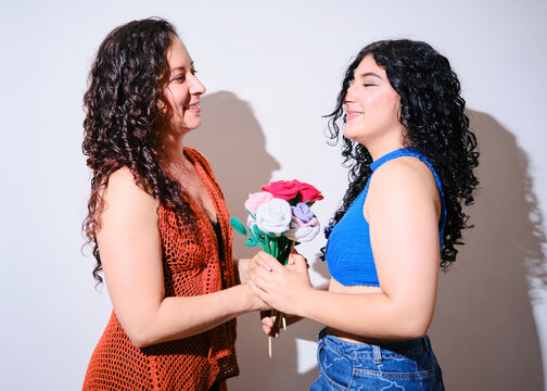 Mother and daughter and a bouquet of crocheted flowers