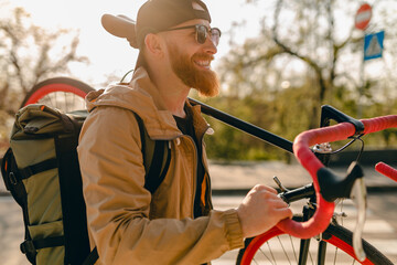 handsome bearded man traveling with bicycle in morning