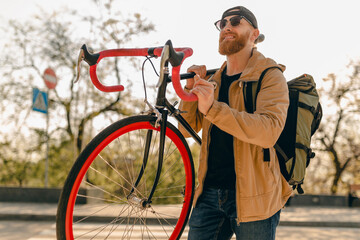 handsome bearded man traveling with bicycle in morning
