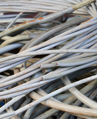 tangle of discarded electrical cables to recover the precious copper inside them
