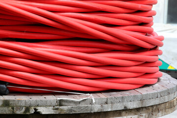 massive red electrical cable spool for distributing high-voltage electricity